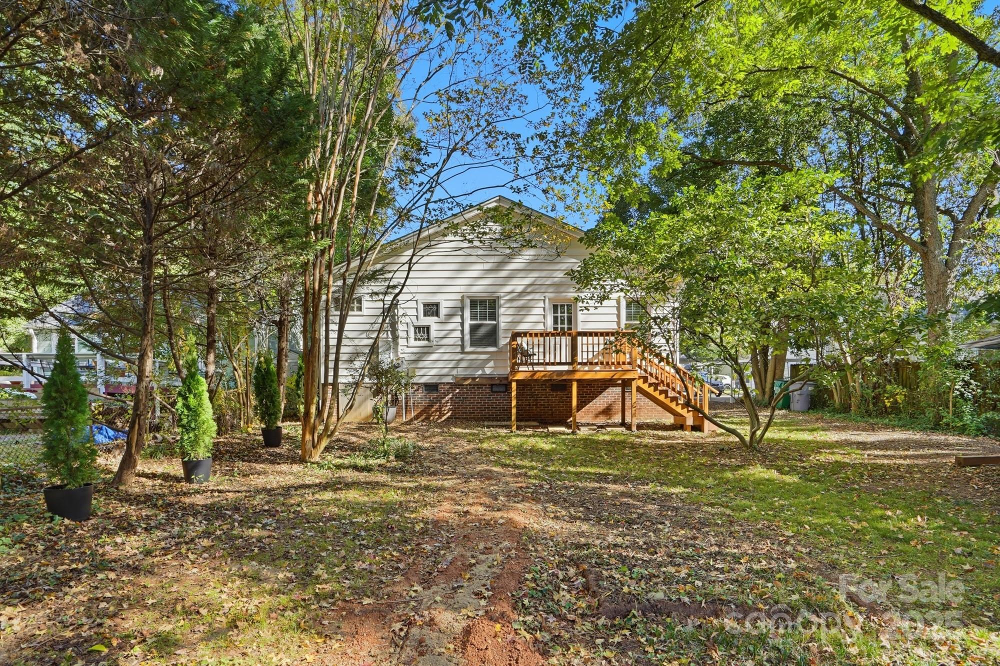 3108 Westmoreland Avenue Charlotte, NC 28205 - Photo 23 of 27 a view of a house with large trees and a small yard