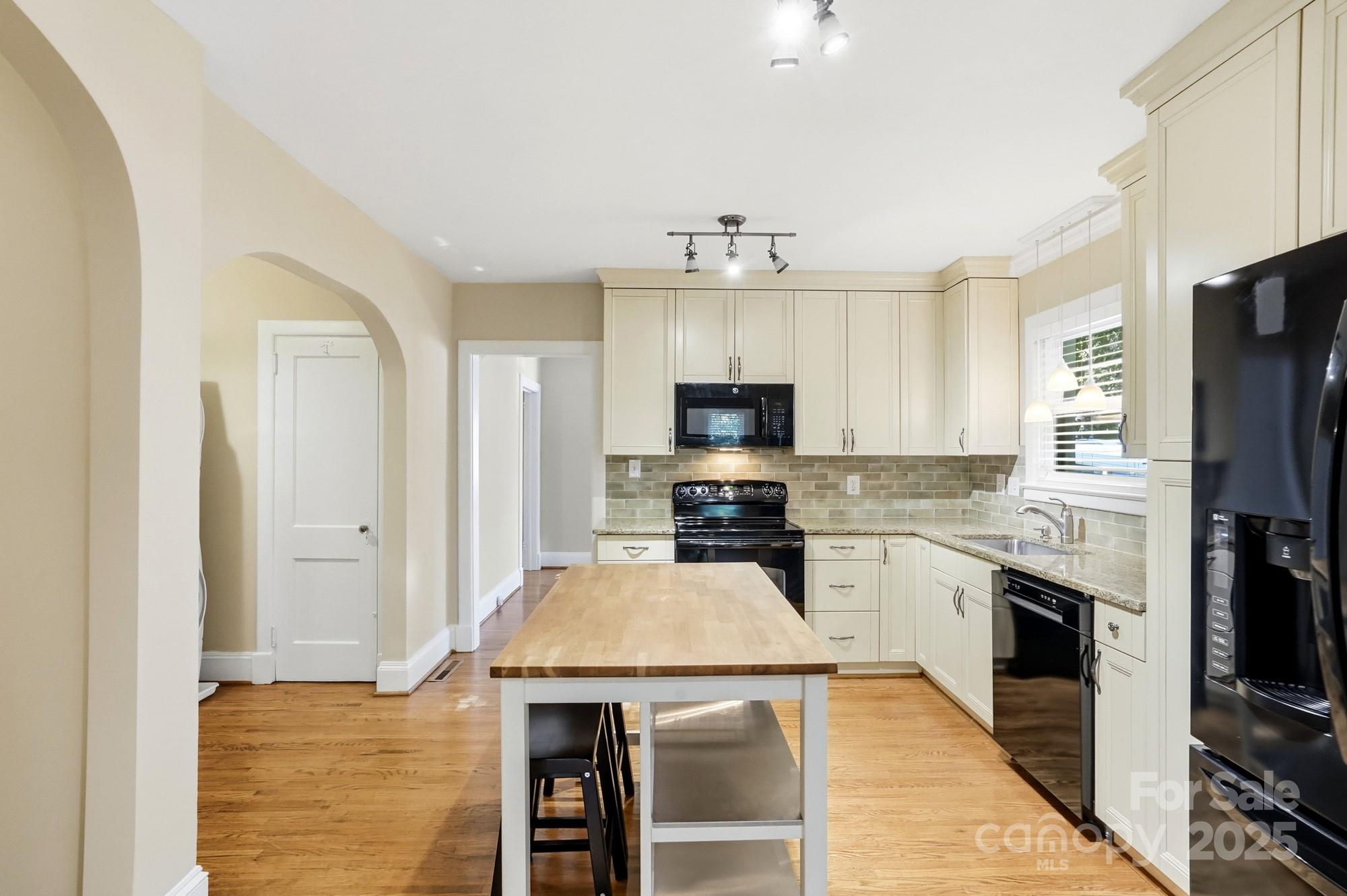 3108 Westmoreland Avenue Charlotte, NC 28205 - Photo 8 of 27 a kitchen with stainless steel appliances a stove refrigerator sink and microwave
