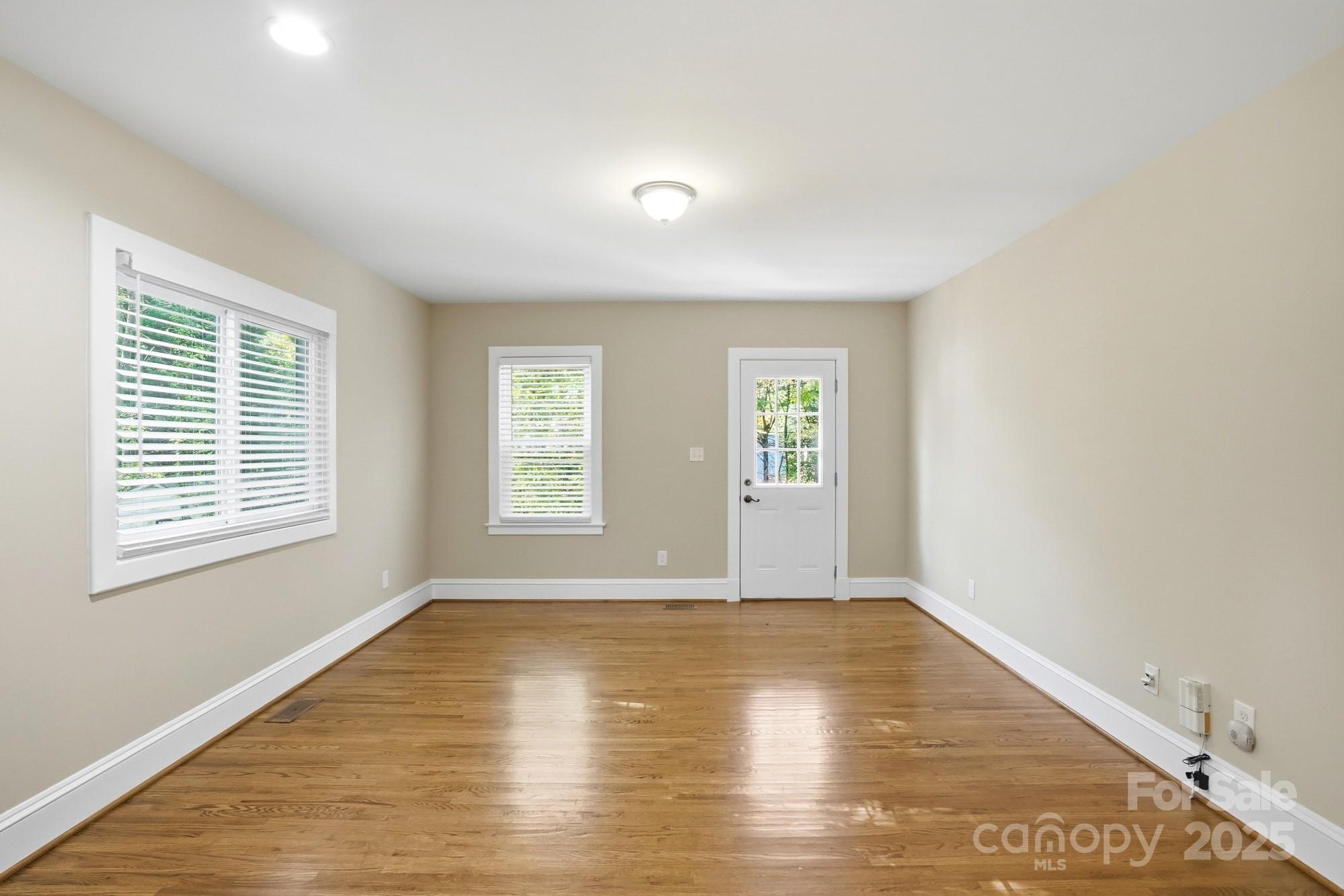 3108 Westmoreland Avenue Charlotte, NC 28205 - Photo 9 of 27 an empty room with wooden floor and windows