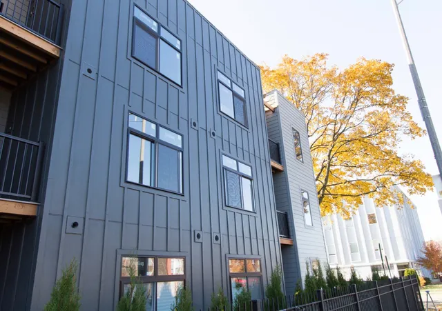 a view of a brick building next to a yard