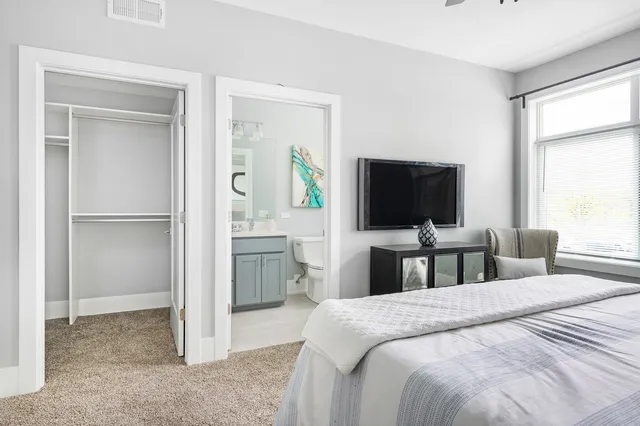 a bedroom with a bed and a flat screen tv