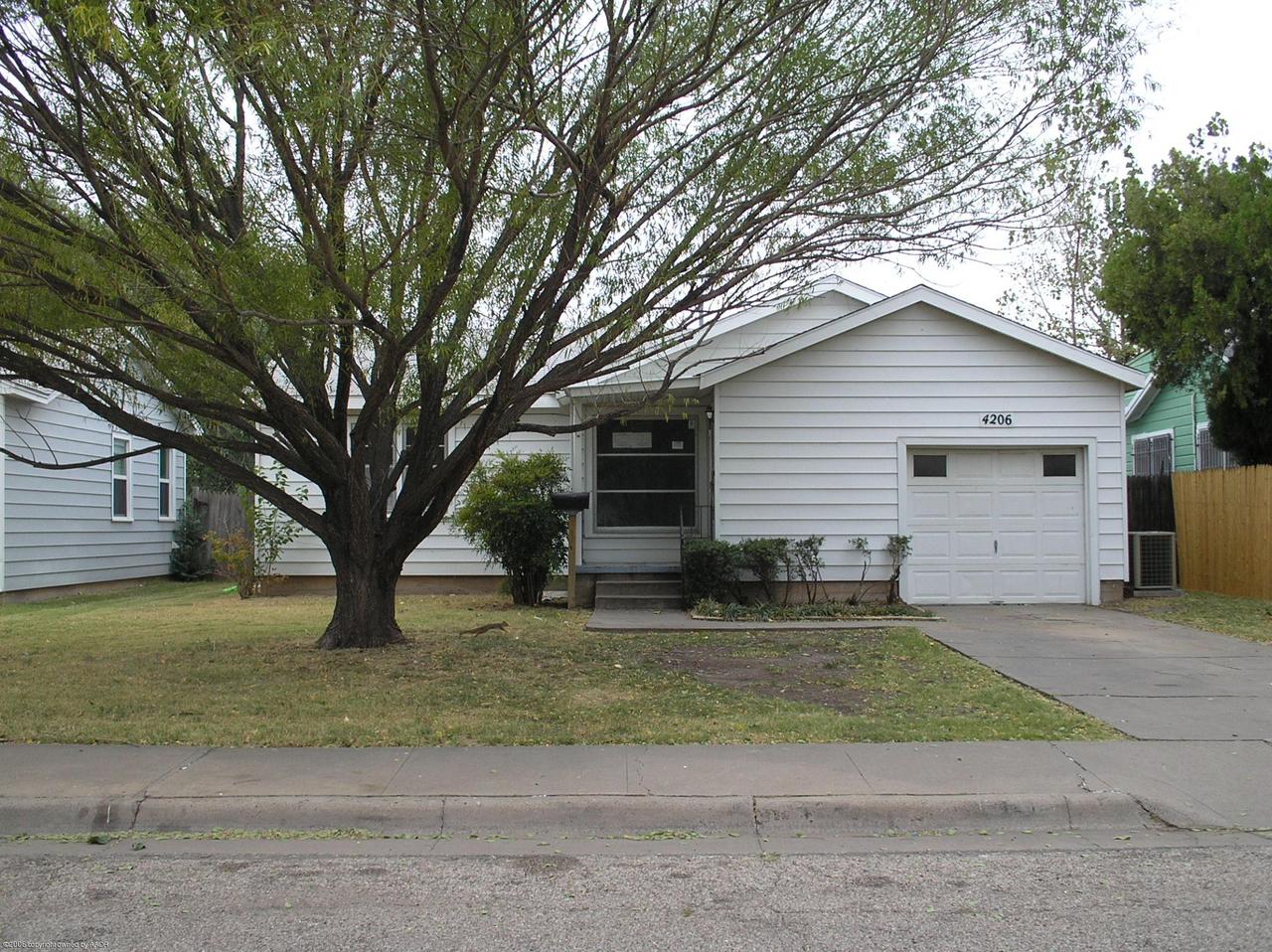 4206 South Lipscomb Street Amarillo, TX 79110 - Photo 1 of 1 a front view of a house with a yard and garage