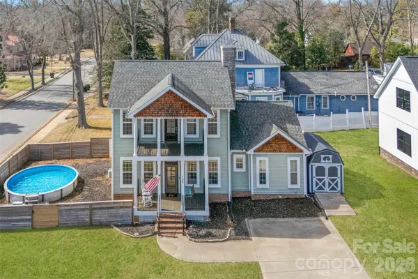 a front view of a house with a yard fire pit and outdoor seating