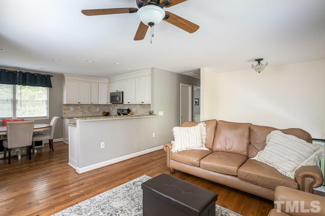 1017 Mockingbird Drive Raleigh, NC 27615 - Photo 12 of 12 Wide open floor plan connects the comfortable Family Room to the Kitchen and Dining area with tons of natural light and a gorgeous WOODED view. Wood flooring throughout the main level living areas.