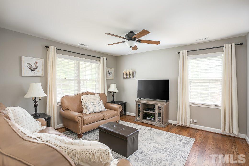 1017 Mockingbird Drive Raleigh, NC 27615 - Photo 3 of 12 DESIGNER GREY PAINTED Family Room has direct access to Kitchen Dining area that overlooks the HUGE backyard through large windows that flood the home with TONS OF NATURAL LIGHT! The OPEN SPACES are perfect for entertaining! Plenty of room for everyone!