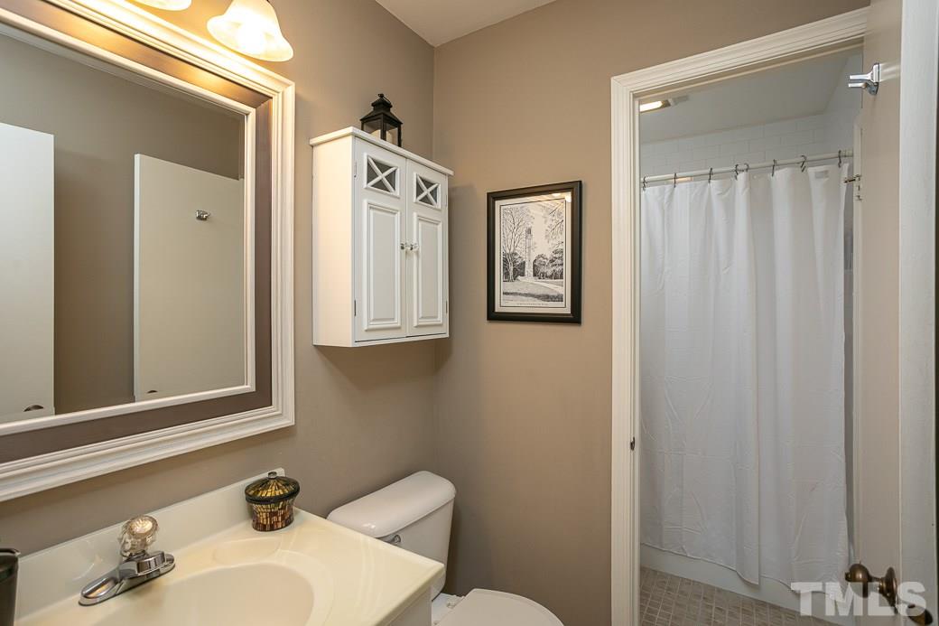 1017 Mockingbird Drive Raleigh, NC 27615 - Photo 5 of 12 Updated Bathroom with new Paint, new TILE, new FIXTURES and new MIRROR.