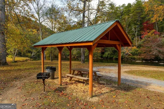 a backyard of a house with table and chairs