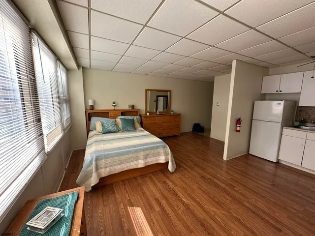 a spacious bedroom with a bed and a view of bedroom