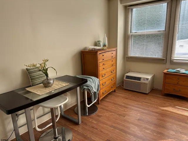 a bedroom with a bed and a desk