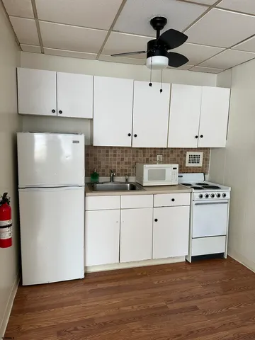 a white refrigerator freezer sitting inside of a kitchen
