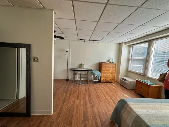 a bathroom with a sink a toilet a mirror and shower curtain