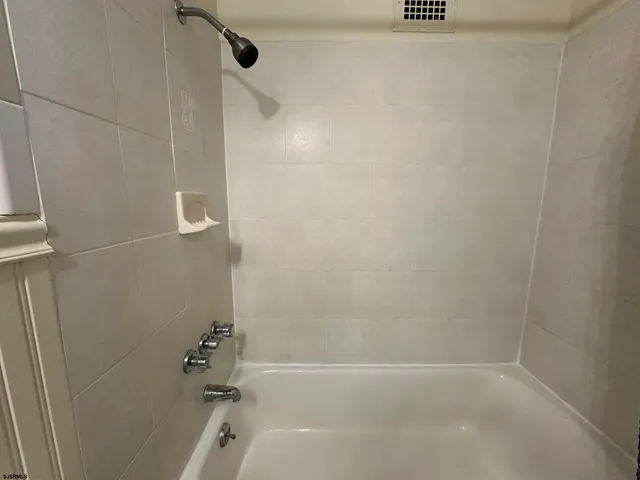 a bathroom with a sink a mirror and shower curtain