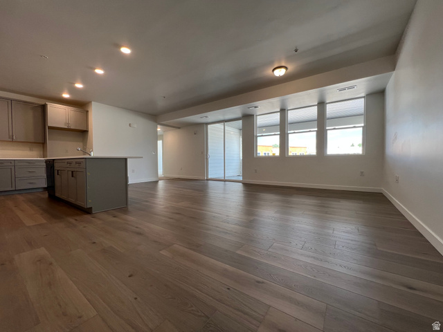 717 West W Coho Lane South, Unit 2F302 Midvale, UT 84047 - Photo 4 of 22 Open-concept living space with wide-plank wood-finish flooring and recessed lighting