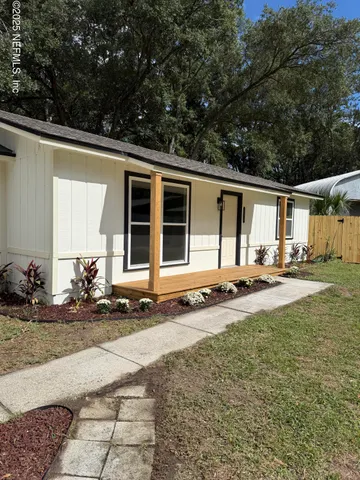 a backyard of a house with yard and outdoor seating
