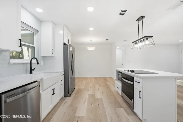 a view of a room with wooden floor and window