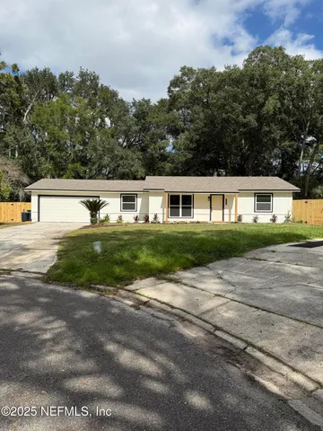a kitchen with granite countertop white cabinets and sink
