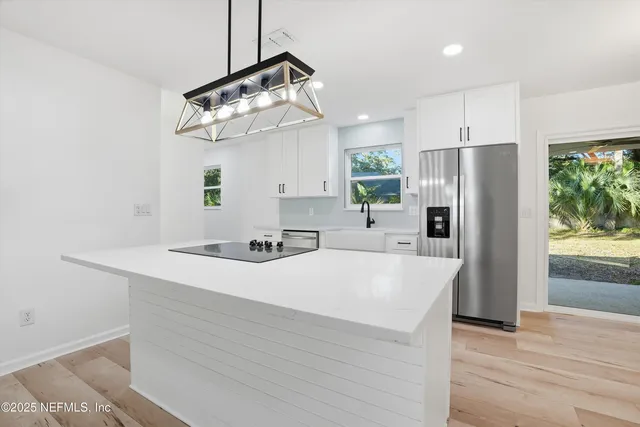 a kitchen with a sink appliances and cabinets