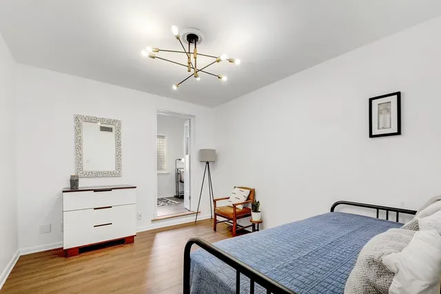 a bedroom with furniture and wooden floor