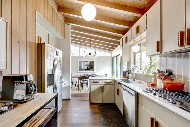 a kitchen with lots of counter top space and wooden floor