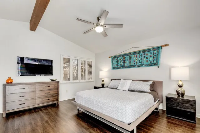 a bedroom with a bed and flat screen tv