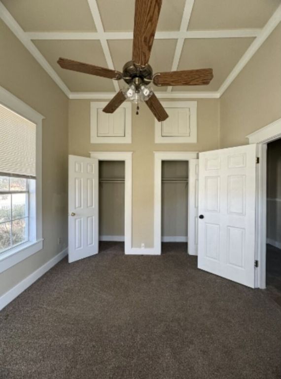 302 South Burleson Street Kyle, TX 78640 - Photo 8 of 18 a view of empty room with windows and ceiling fan