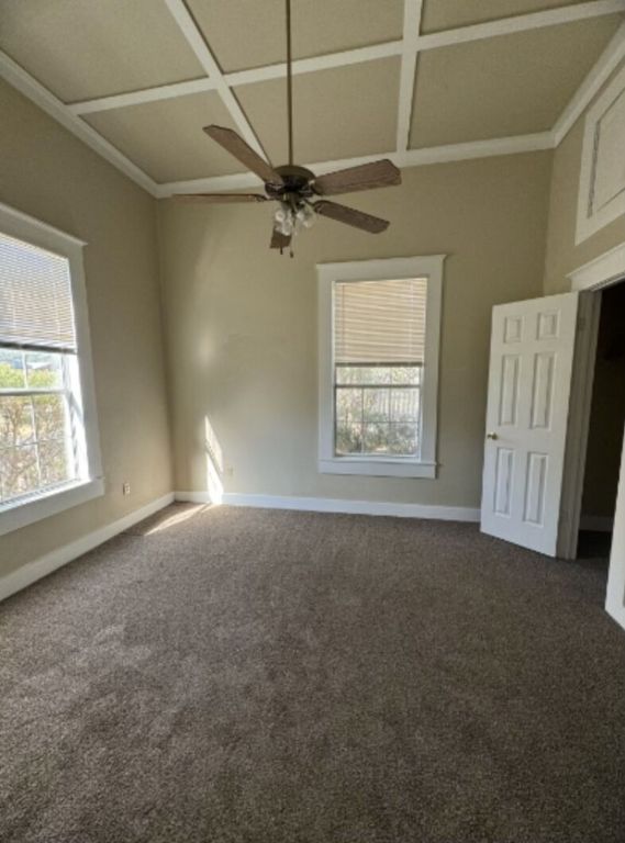 302 South Burleson Street Kyle, TX 78640 - Photo 9 of 18 an empty room with windows and fan