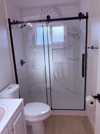 a bathroom with a shower and a toilet