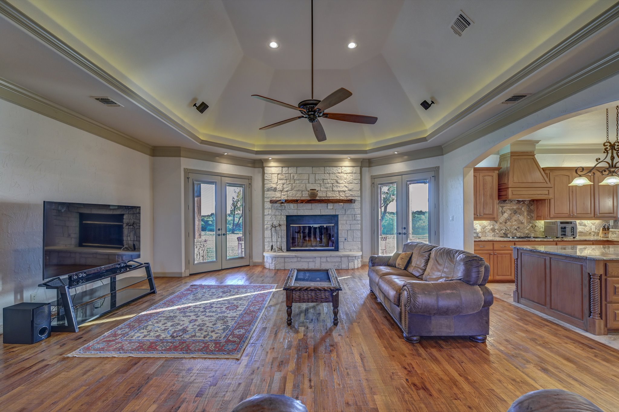 18601 County Road 214 Brookesmith, TX 76827 - Photo 8 of 39 Main House: Living area with french doors, healthy amount of natural light, ornamental molding, light wood-style flooring, and a fireplace