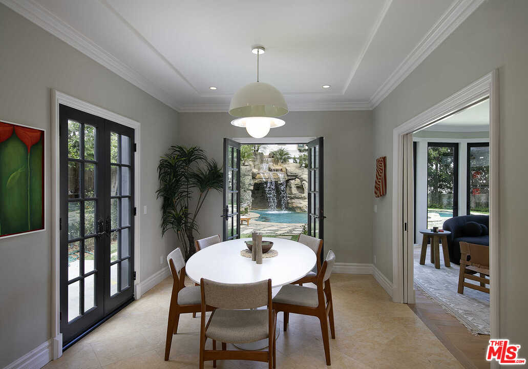 910 North Rexford Drive Beverly Hills, CA 90210 - Photo 13 of 32 a dining room with furniture window and wooden floor