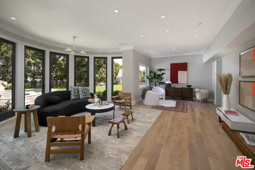 910 North Rexford Drive Beverly Hills, CA 90210 - Photo 14 of 32 a living room with furniture and large windows