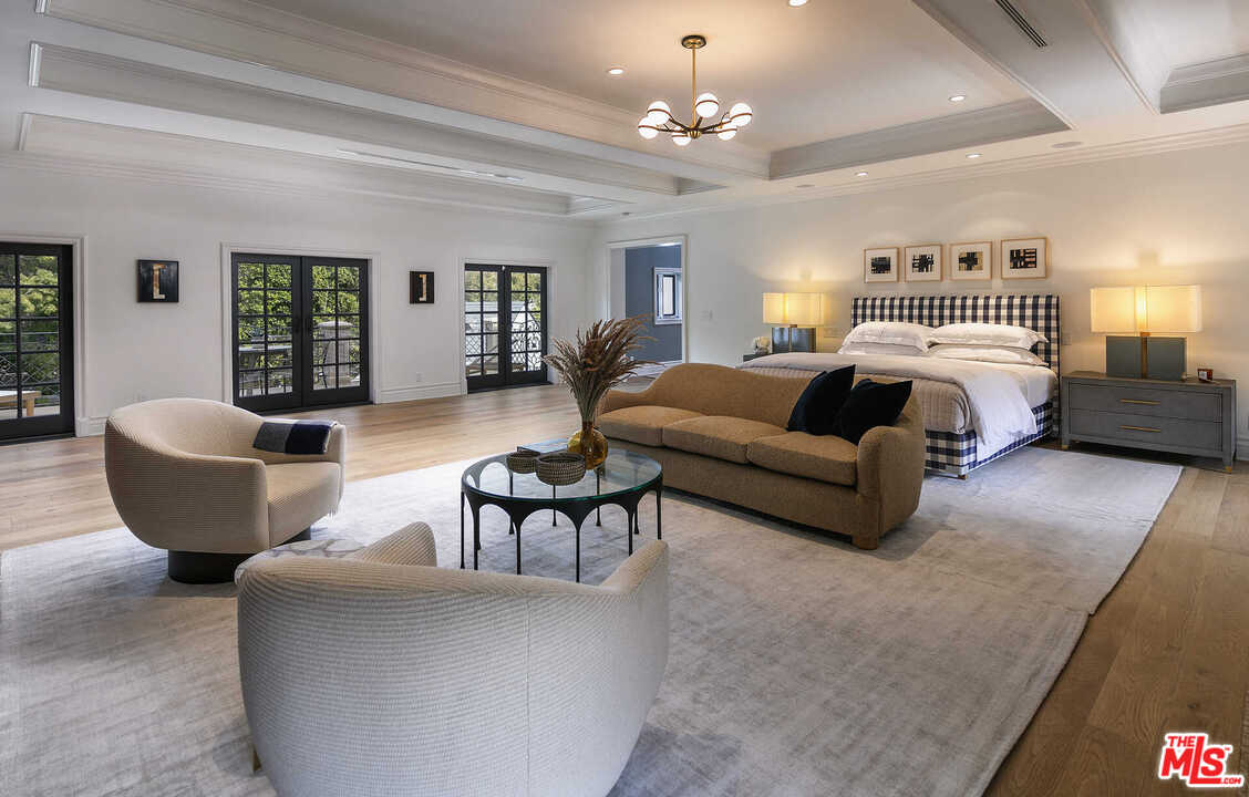 910 North Rexford Drive Beverly Hills, CA 90210 - Photo 17 of 32 a living room with furniture and a chandelier