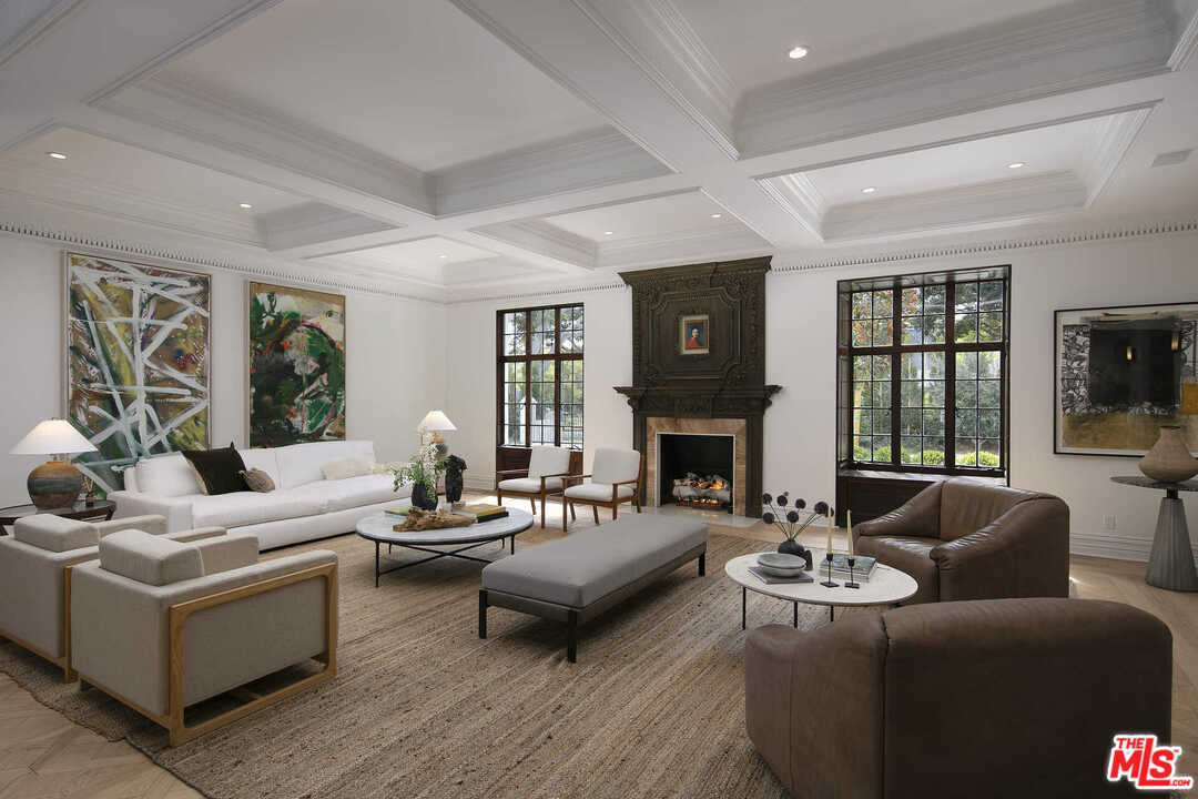 910 North Rexford Drive Beverly Hills, CA 90210 - Photo 3 of 32 a living room with furniture fireplace and a large window