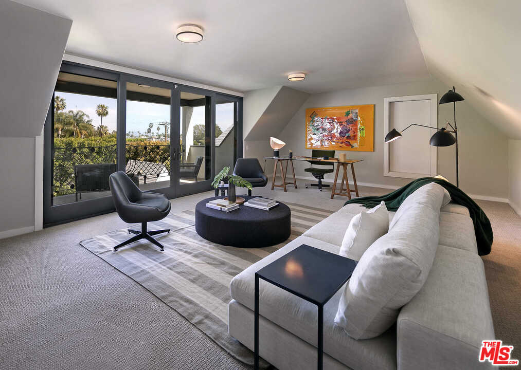 910 North Rexford Drive Beverly Hills, CA 90210 - Photo 21 of 32 a living room with furniture and a large window