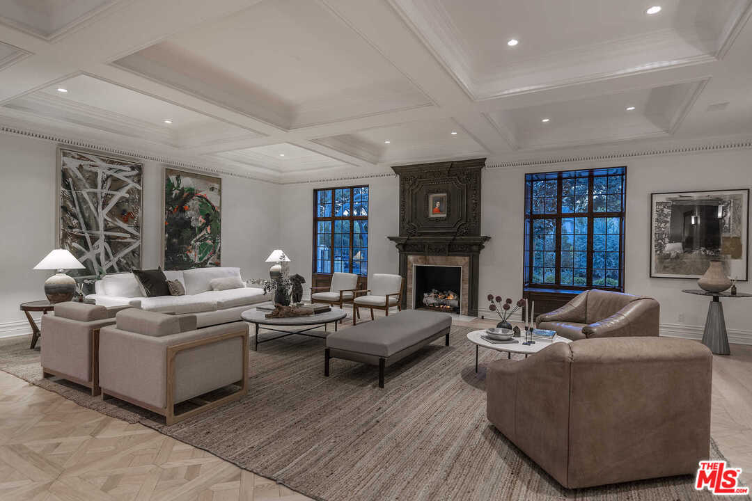 910 North Rexford Drive Beverly Hills, CA 90210 - Photo 29 of 32 a living room with furniture a fireplace and a large window