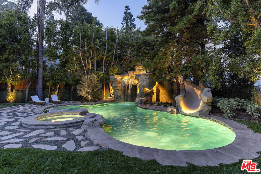 910 North Rexford Drive Beverly Hills, CA 90210 - Photo 30 of 32 a view of a swimming pool with a yard and outdoor seating