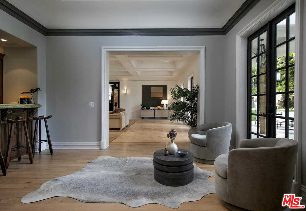 910 North Rexford Drive Beverly Hills, CA 90210 - Photo 6 of 32 a living room with furniture and a potted plant