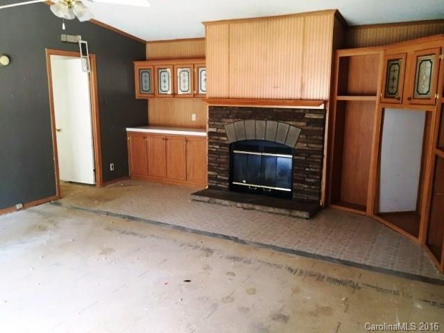 270 Freeze Meadows Road China Grove, NC 28023 - Photo 2 of 7 a living room with a fireplace furniture and a ceiling fan