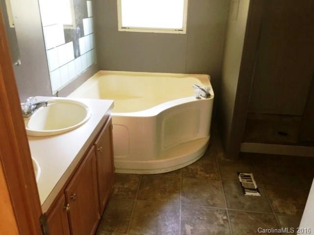 270 Freeze Meadows Road China Grove, NC 28023 - Photo 4 of 7 a bathroom with a tub sink and mirror