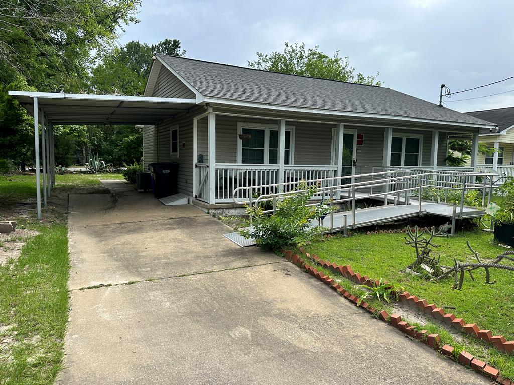 a view of house with swimming pool and porch