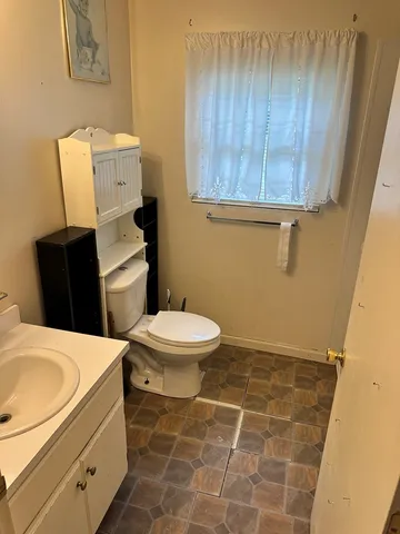 a bathroom with a toilet and a sink