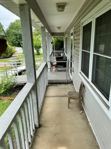 a view of deck with furniture and garden