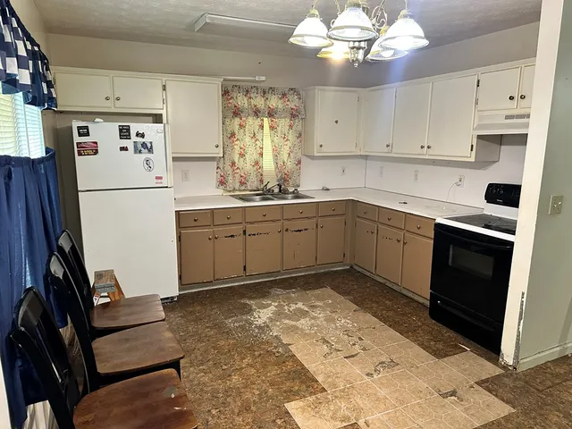 a kitchen with stainless steel appliances granite countertop a refrigerator sink and cabinets