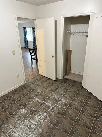 an empty room with closet and mirror