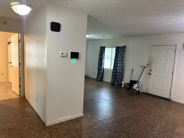 an empty room with windows and closet