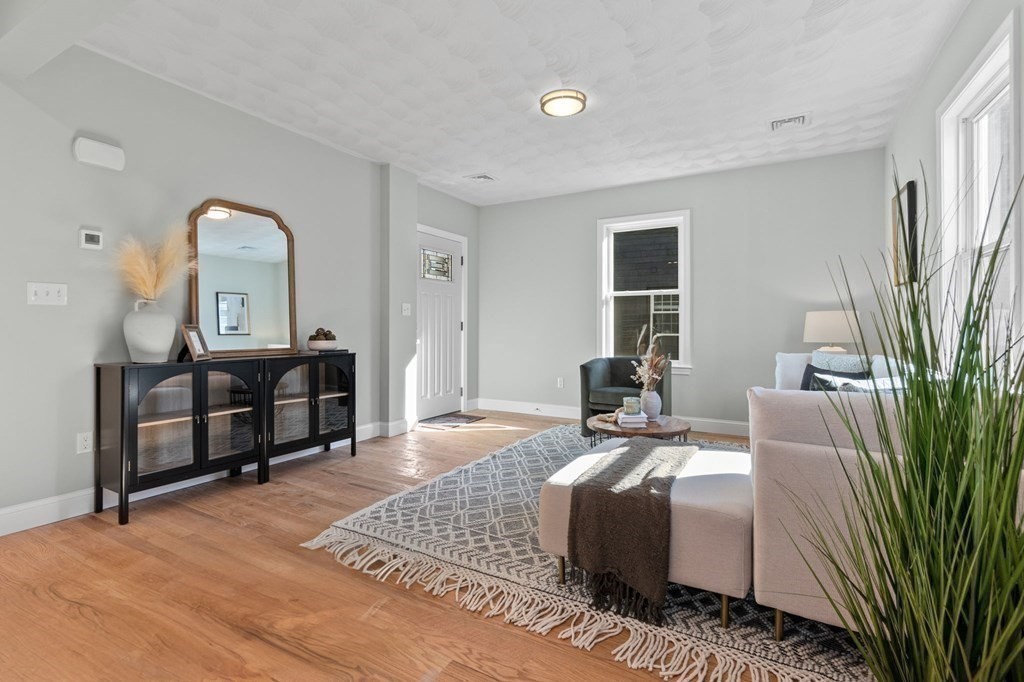 57 Buffum Street, Unit 1 Salem, MA 01970 - Photo 3 of 31 a bed room with a bed and furniture