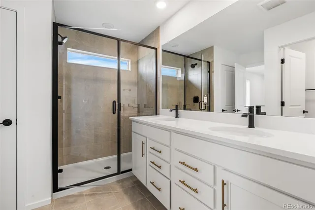 a bathroom with a double vanity sink mirror and double