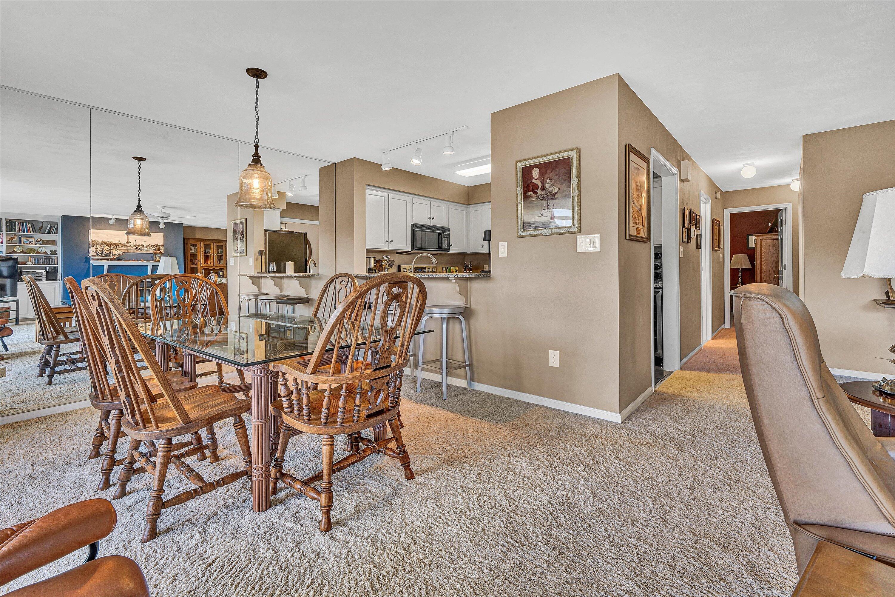 410 Marina Bay Drive, Unit 102 Penhook, VA 24137 - Photo 11 of 38 a view of a dining room with furniture and a chandelier