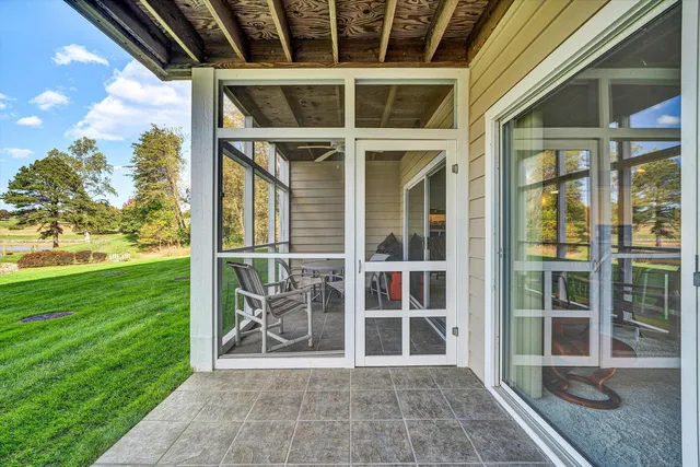 a view of a porch with chairs and backyard