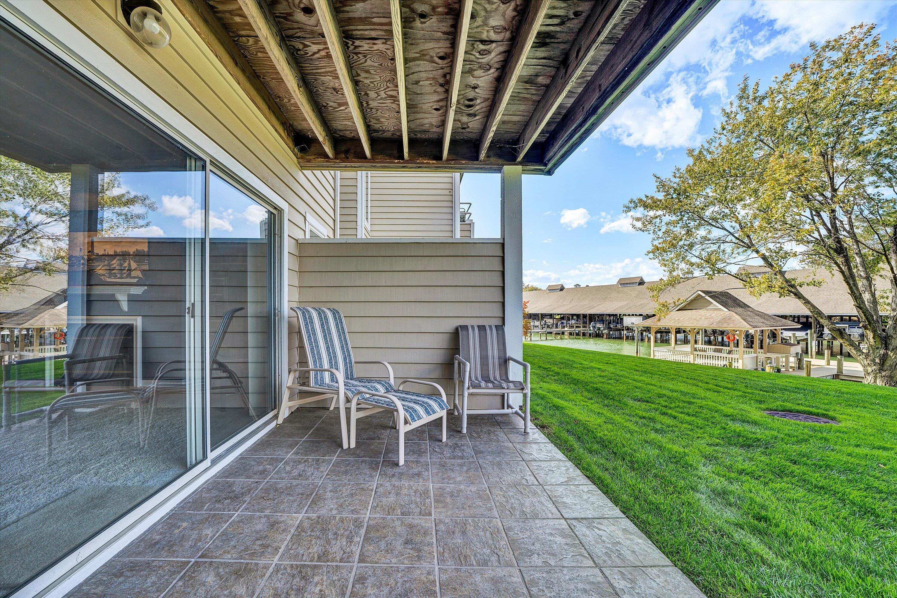 410 Marina Bay Drive, Unit 102 Penhook, VA 24137 - Photo 14 of 38 a view of a porch with chairs and backyard