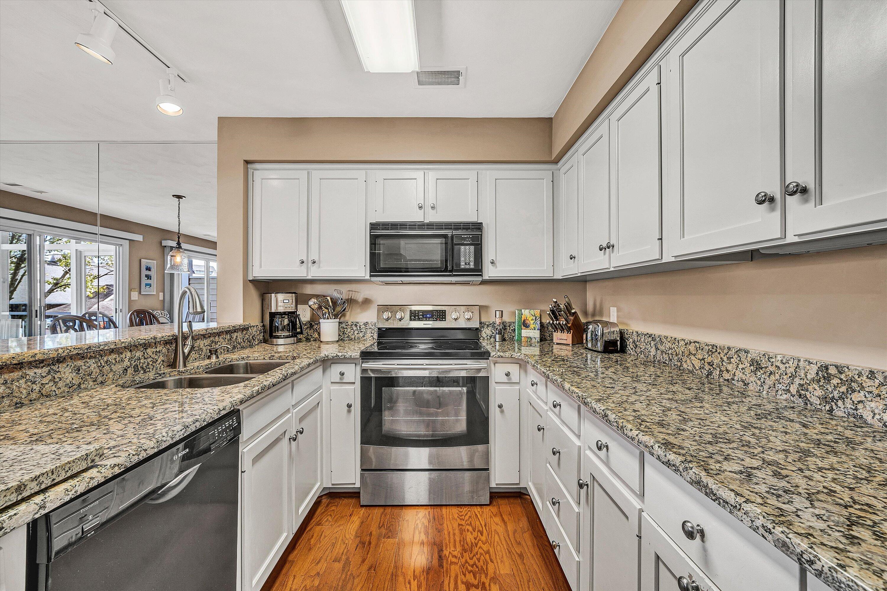 410 Marina Bay Drive, Unit 102 Penhook, VA 24137 - Photo 15 of 38 a kitchen with granite countertop a sink stove and cabinets
